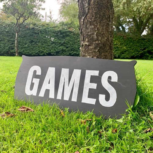 Lawn games to hire - a blackboard style sign with the word 'Games'